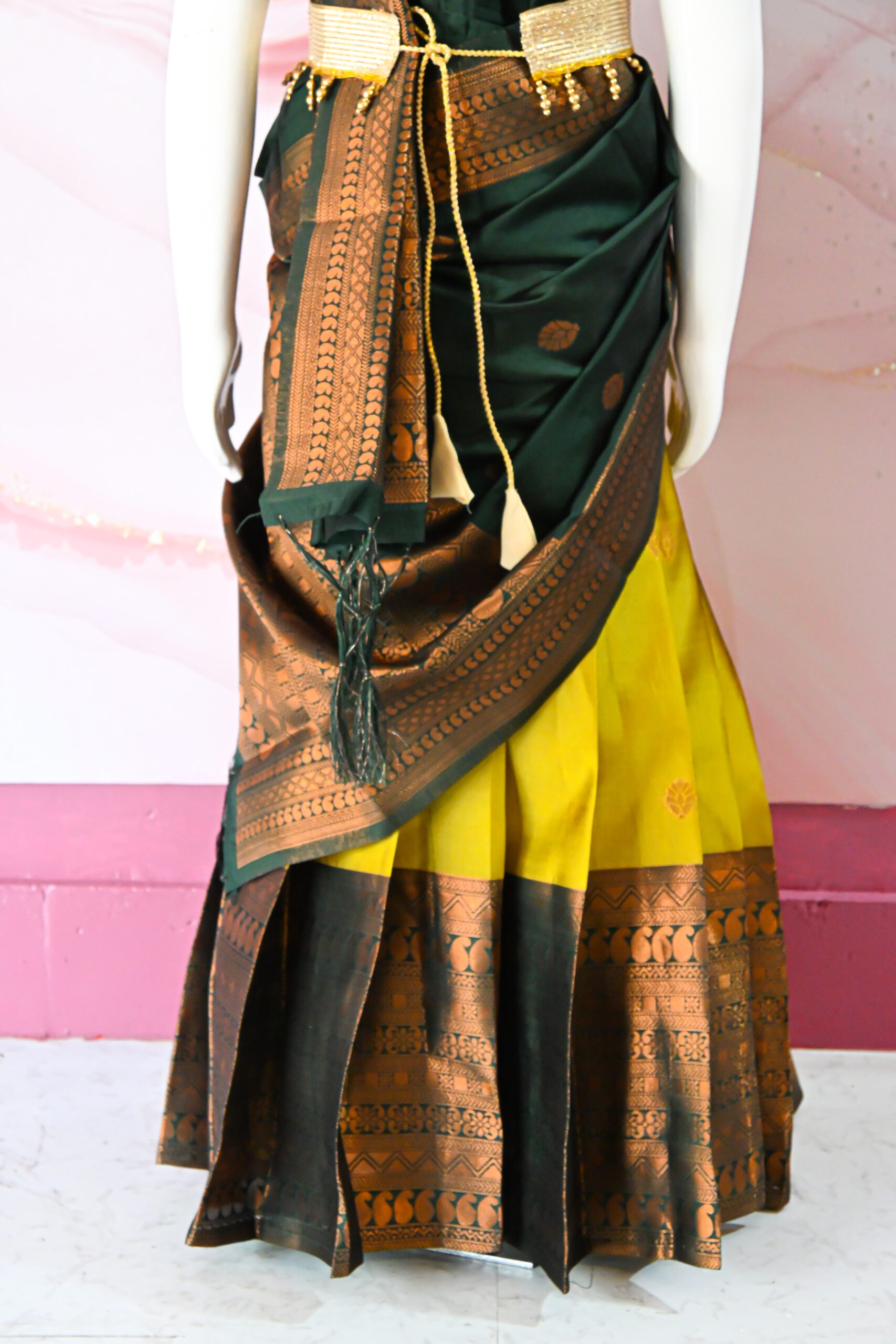 A traditional Indian Pattu Pavada lehenga in a Mustard Yellow with Green