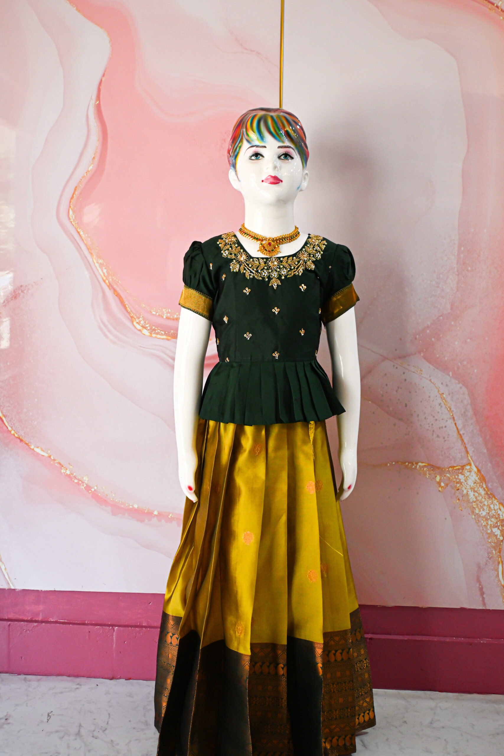 A traditional Indian Pattu Pavada lehenga in a Mustard Yellow with Green