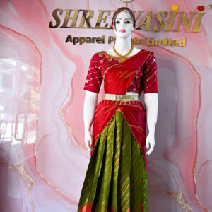 A traditional Indian Pattu Pavada (lehenga) in a vibrant parrot green and pink shade.