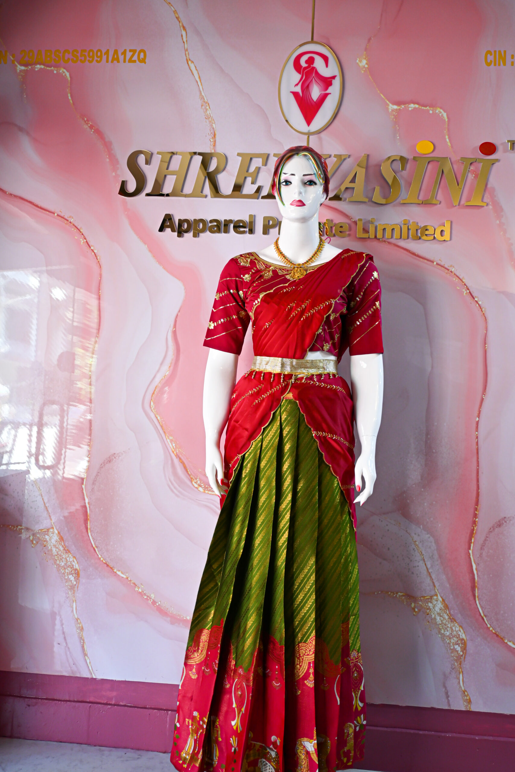A traditional Indian Pattu Pavada (lehenga) in a vibrant parrot green and pink shade.