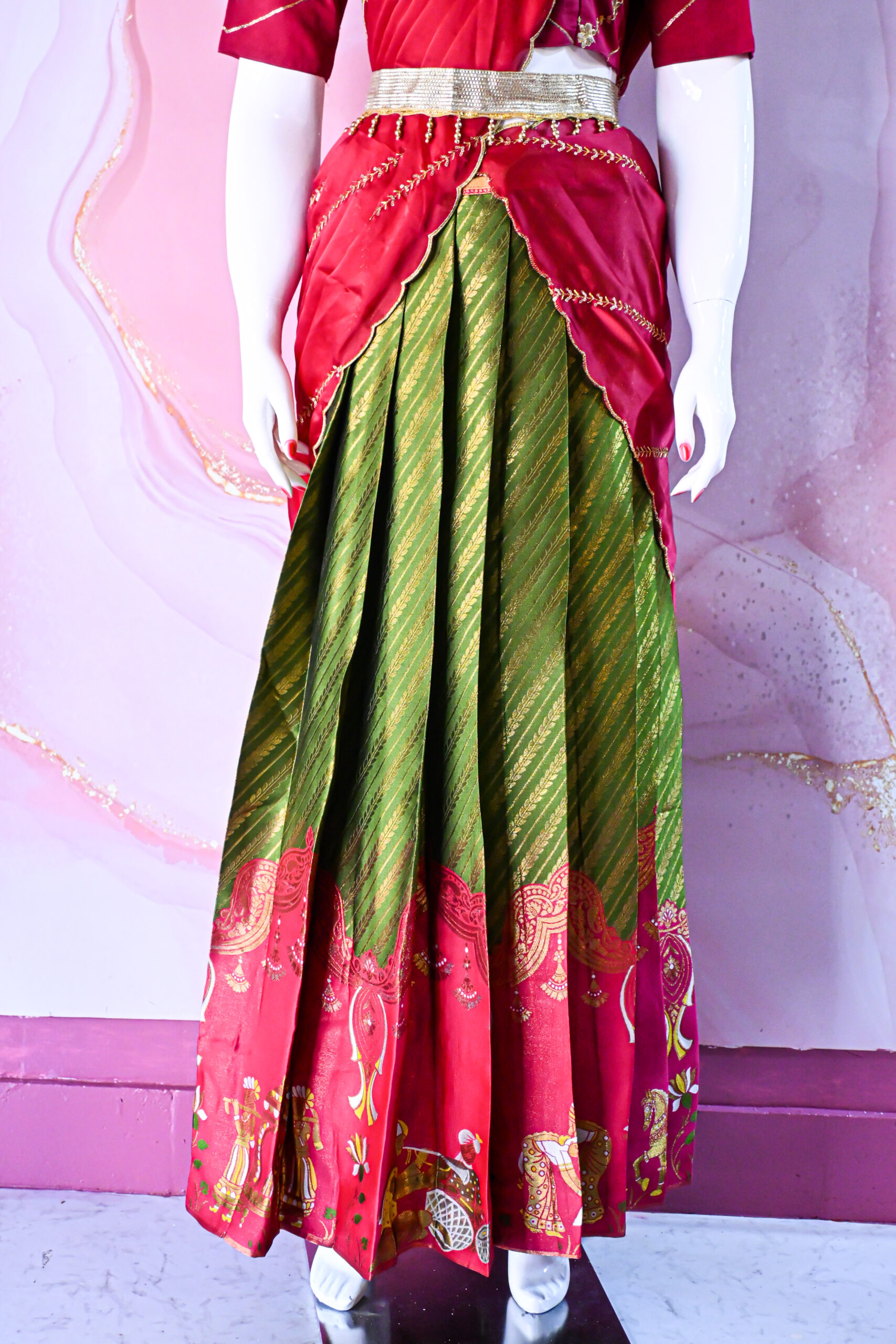 A traditional Indian Pattu Pavada (lehenga) in a vibrant parrot green and pink shade.