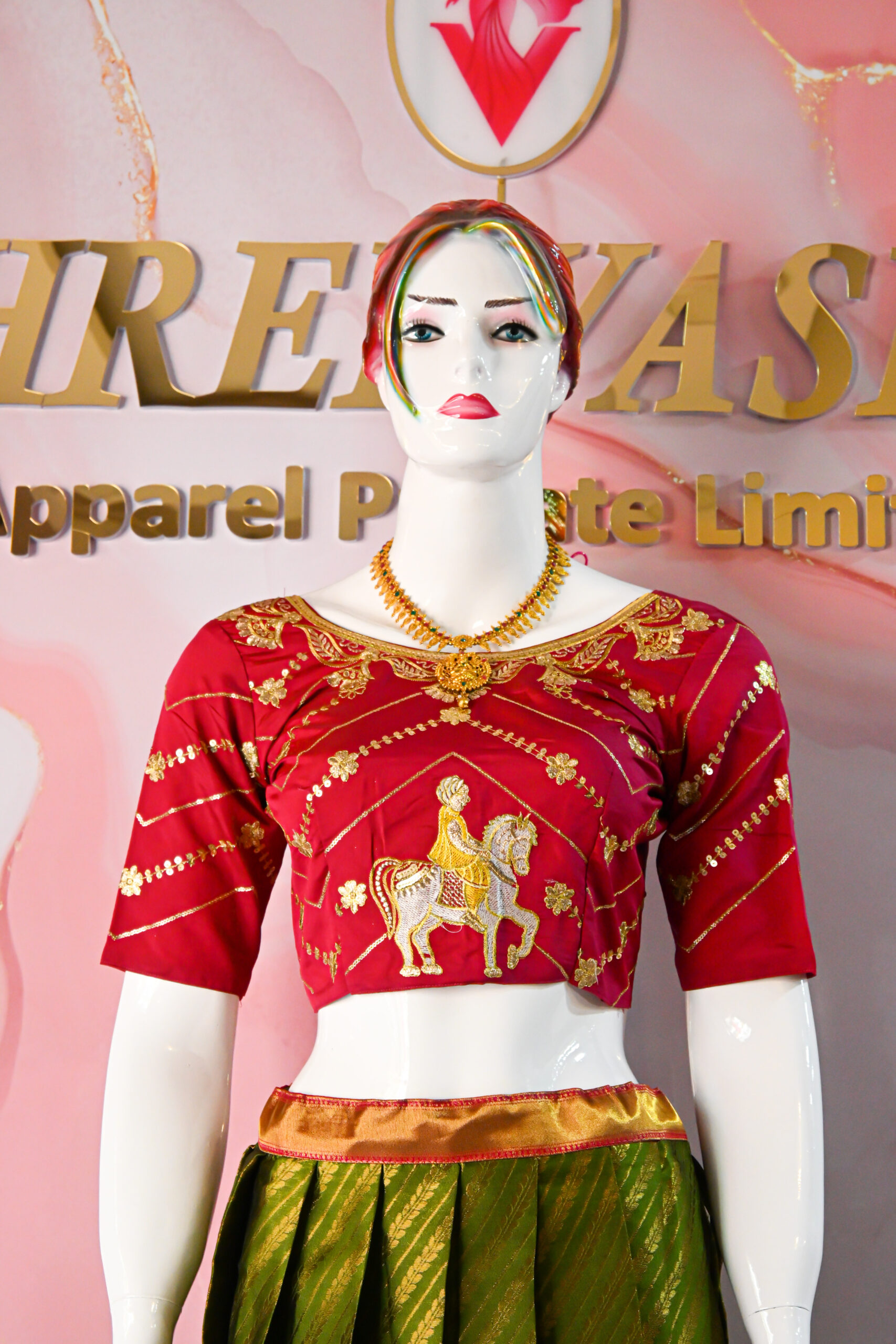 A traditional Indian Pattu Pavada (lehenga) in a vibrant parrot green and pink shade.
