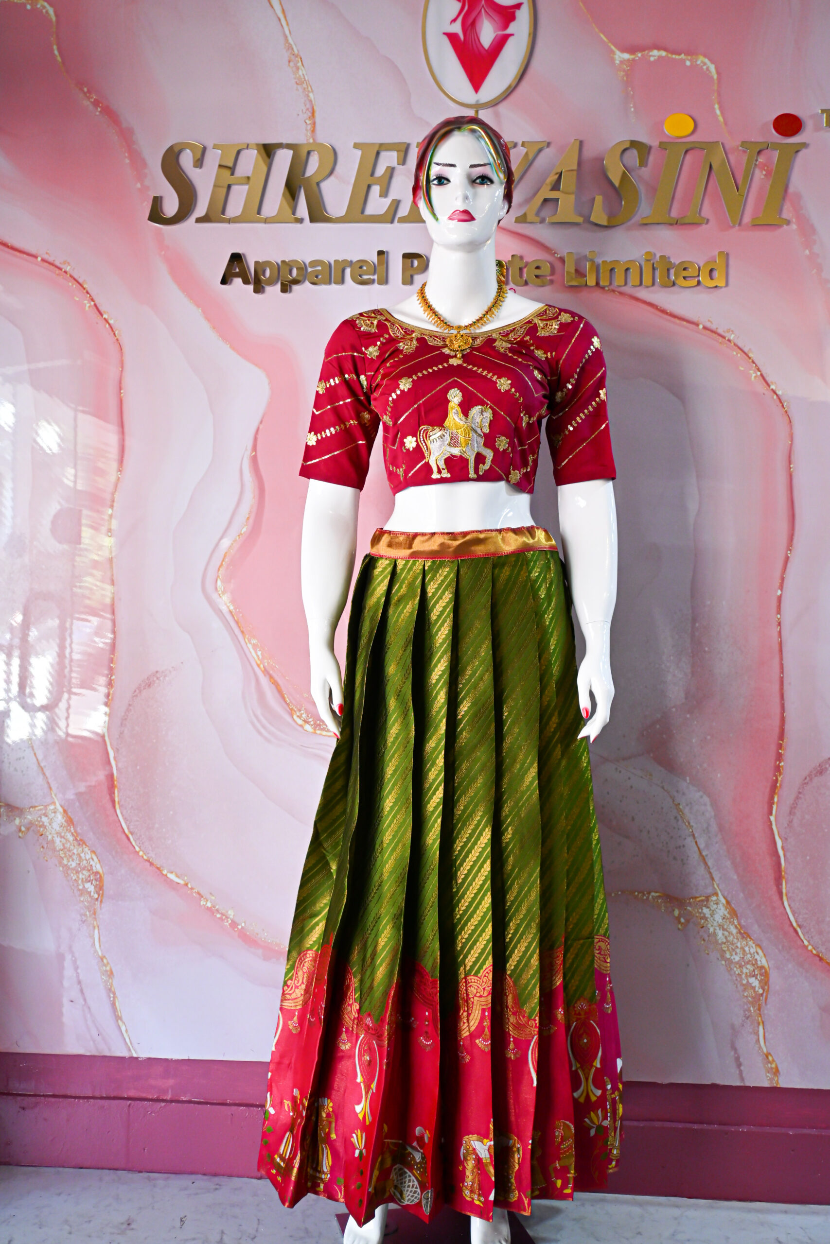 A traditional Indian Pattu Pavada (lehenga) in a vibrant parrot green and pink shade.
