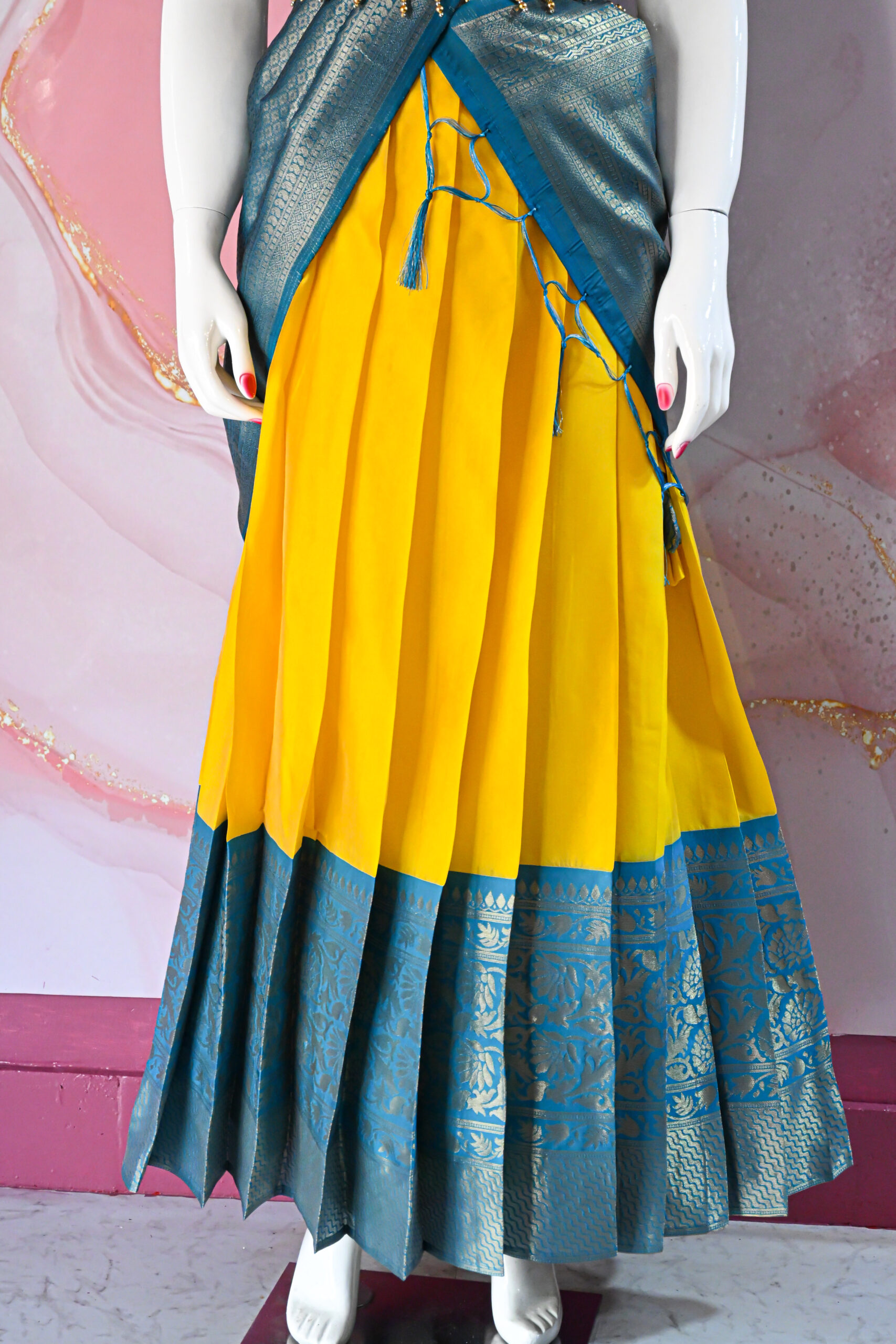 A traditional Indian Pattu Pavada (lehenga) in a vibrant Yellow with Blue.