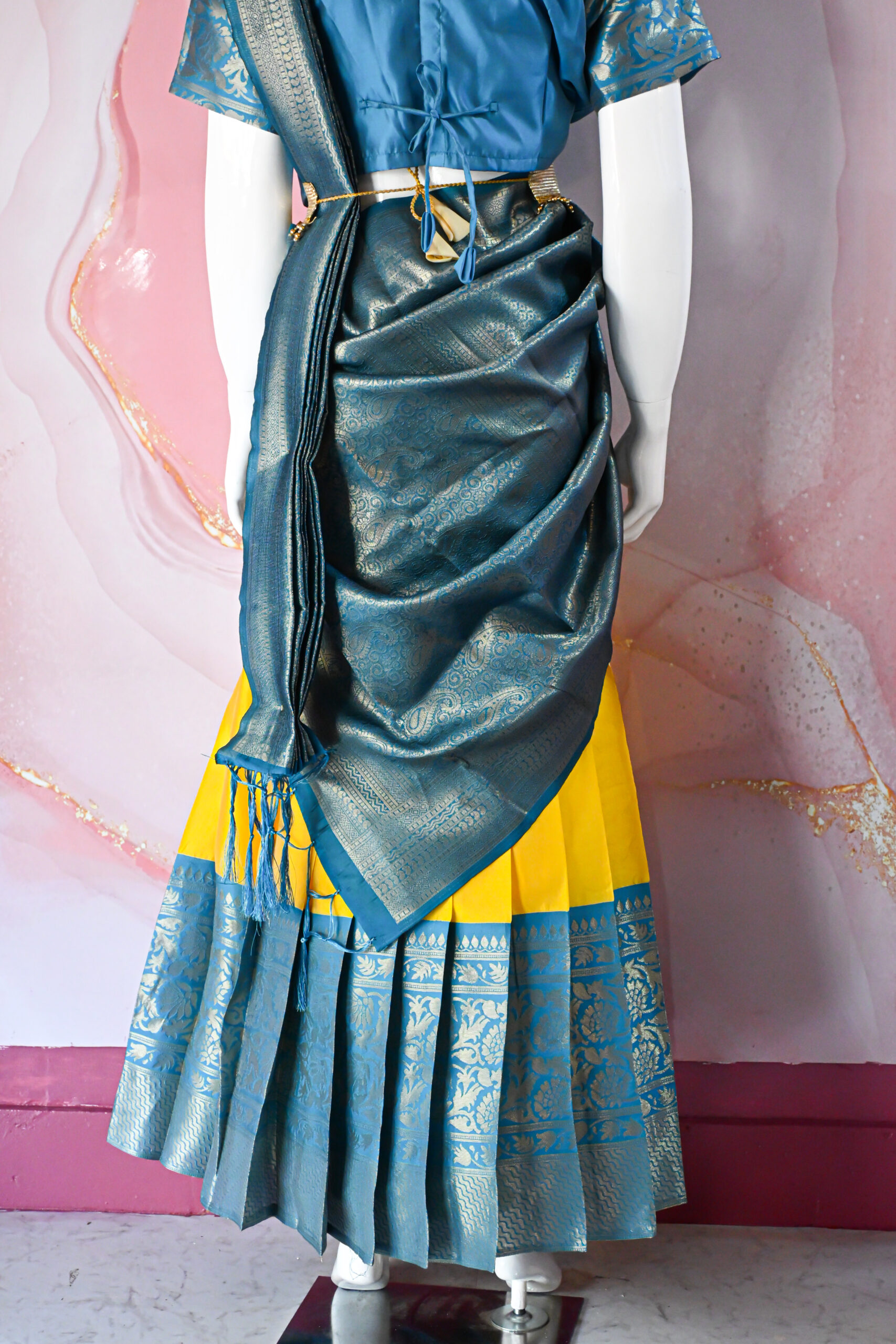 A traditional Indian Pattu Pavada (lehenga) in a vibrant Yellow with Blue.